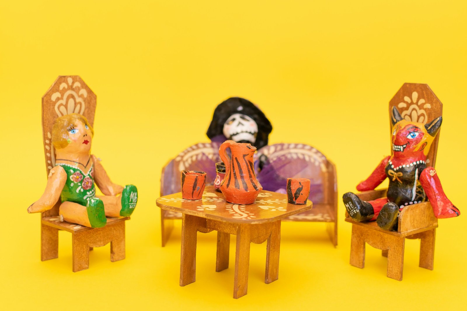 a group of dolls sitting on chairs